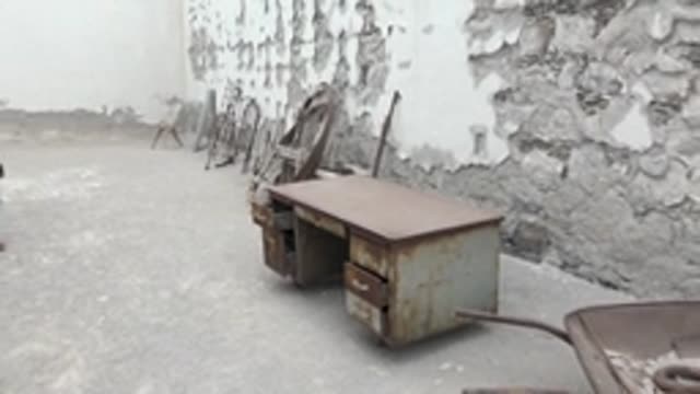 MULEGE BCS MEXICO-2022: Two People Walking Through Abandoned Courtyard