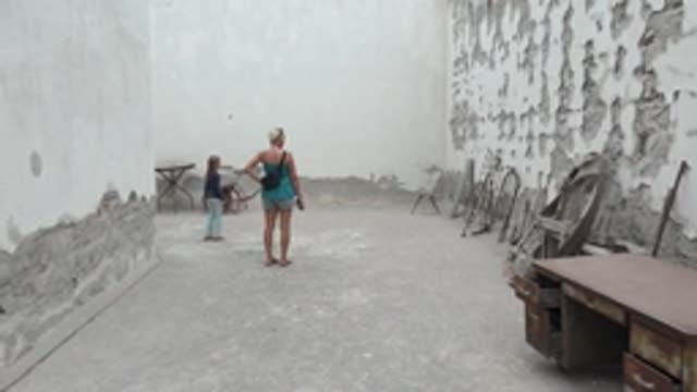 MULEGE BCS MEXICO-2022: Child Pushing Wheelbarrow in Worn Courtyard