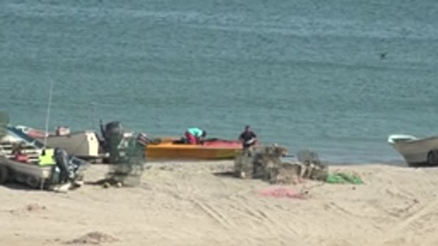 SAN JUANICO BCS MEXICO-2022: Fishermen Preparing Boats on Sandy Shore