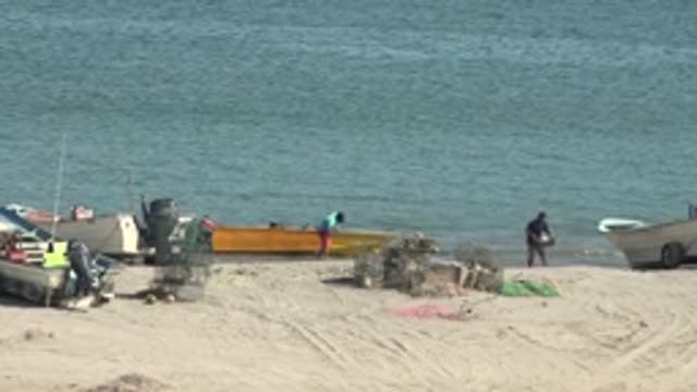 SAN JUANICO BCS MEXICO-2022: People and Boats on a Sandy Beach