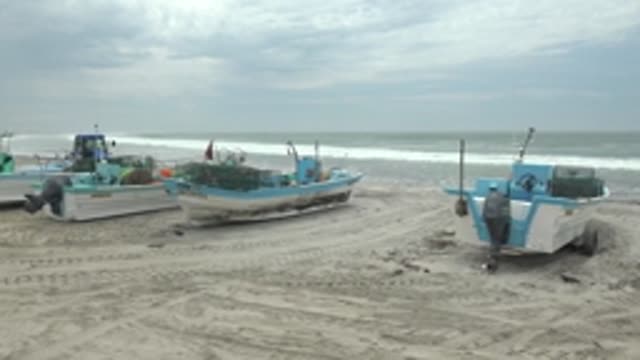 PUENTA ABREOJOS BCS MEXICO-2022: Fishing Boats on Sandy Beach with People Moving