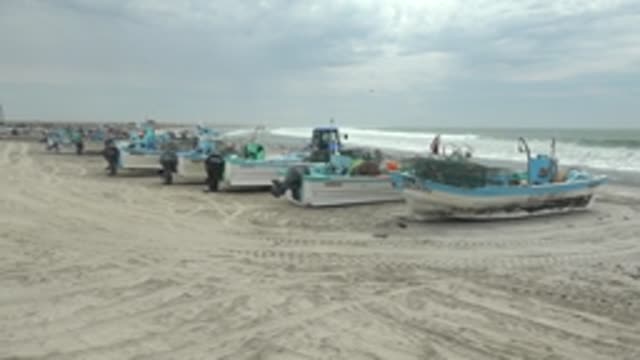 PUENTA ABREOJOS BCS MEXICO-2022: Fishing Boats on Sandy Beach with Person Walking