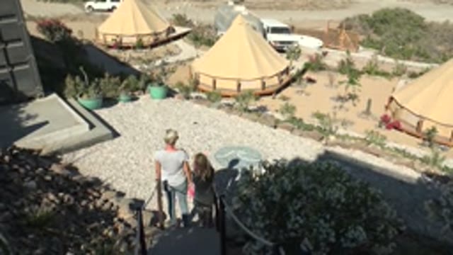 SAN JUANICO BCS MEXICO-2022: Couple Walking Down Steps Toward Tented Courtyard