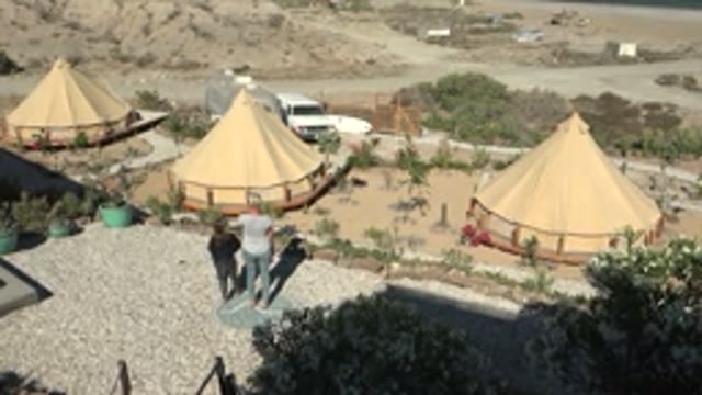 SAN JUANICO BCS MEXICO-2022: Two People Walking near Desert Yurts