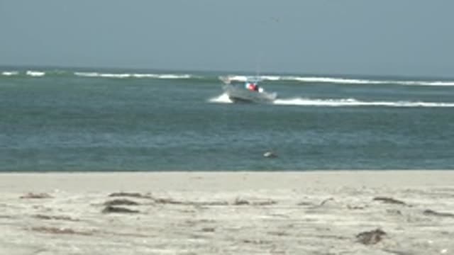 LA BOCANA BCS MEXICO-2022: Speeding Boat Near Sandy Shore With Ocean Waves