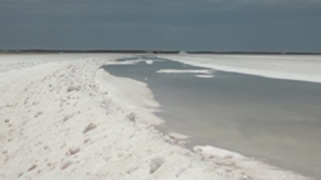GUERRERO NEGRO BCS MEXICO-2022: Snowy Path Beside Frozen Water Surface