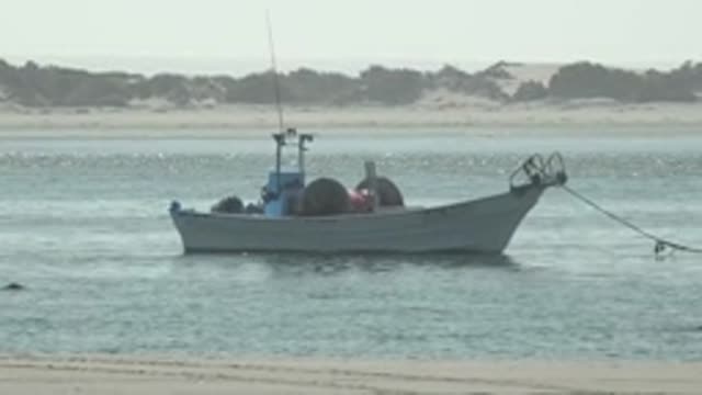 LA BOCANA BCS MEXICO-2022: Small Fishing Boat Anchored near Sandy Shore
