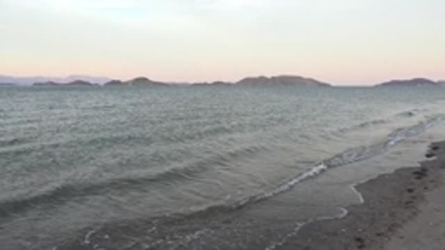 BAHIA DE LOS ANGELES BCS MEXICO-2022: Gentle Ocean Waves Rolling Onto Sandy Shore