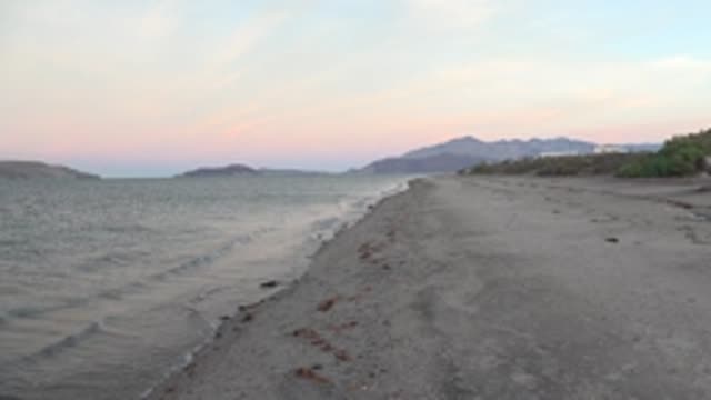 BAHIA DE LOS ANGELES BCS MEXICO-2022: Gentle Ocean Waves on Sandy Beach at Dusk