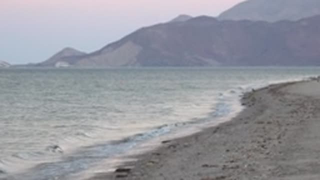 BAHIA DE LOS ANGELES BCS MEXICO-2022: Gentle Waves Lapping Rocky Shore with Distant Mountains