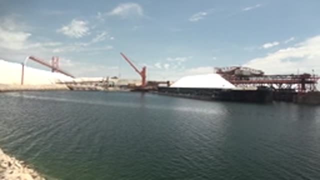 GUERRERO NEGRO BCS MEXICO-2022: Industrial Port with White Mounds and Cranes by Water