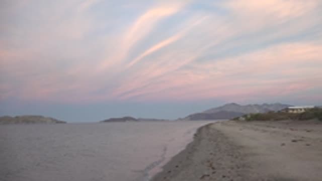 BAHIA DE LOS ANGELES BCS MEXICO-2022: Gentle Waves Lapping at a Sandy Beach at Sunset