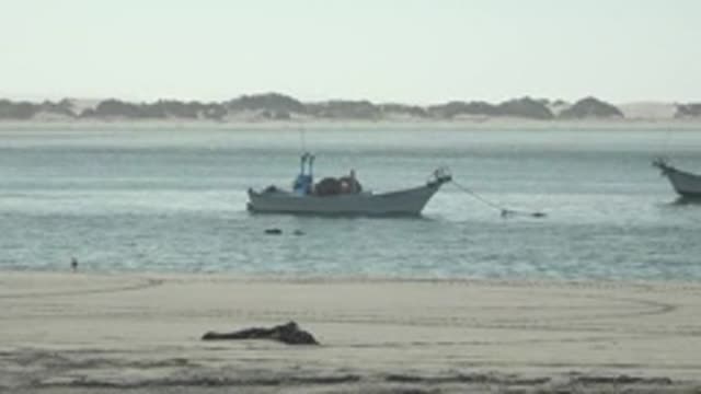 LA BOCANA BCS MEXICO-2022: Boats and Car Moving on Sandy Beach