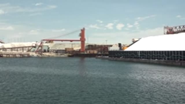 GUERRERO NEGRO BCS MEXICO-2022: Cranes and White Storage Piles at Industrial Port