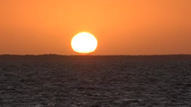 SAN CARLOS BCS MEXICO-2022: Sun Setting Over Calm Ocean Horizon