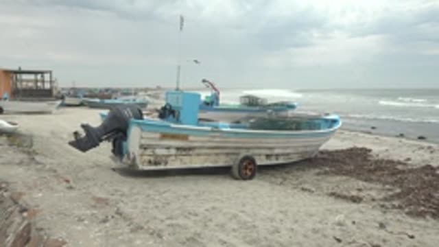 PUENTA ABREOJOS BCS MEXICO-2022: Fishing Boat on Sandy Beach with Ocean Waves