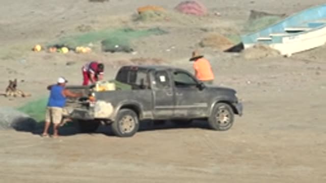 SAN JUANICO BCS MEXICO-2022: Fishing Crew Unloading Gear From Pickup Truck