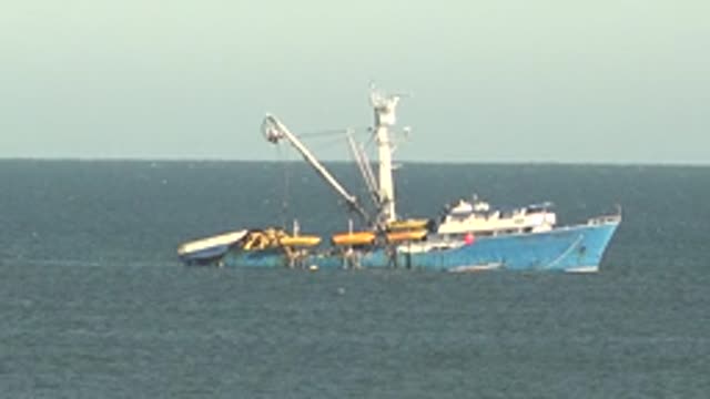 SAN JUANICO BCS MEXICO-2022: Fishing Vessel with Crane on Calm Ocean Waters