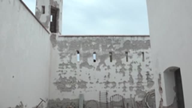 MULEGE BCS MEXICO-2022: Courtyard with White-Washed Walls and Crenellated Tower