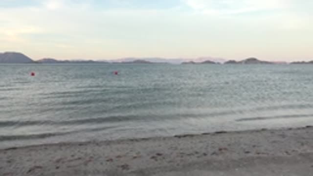 BAHIA DE LOS ANGELES BCS MEXICO-2022: Gentle Ocean Waves and Buoys on Sandy Shore