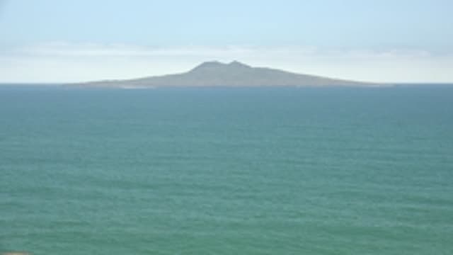 SAN QUINTIN BC MEXICO-2022: Distant Island and Boat Moving Across Ocean