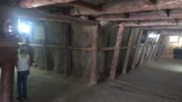 SANTA ROSALIA BCS MEXICO-2022: Person Walking Through Dimly Lit Underground Tunnel