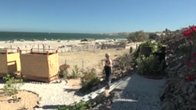 SAN JUANICO BCS MEXICO-2022: People Strolling on a Coastal Gravel Path by the Beach