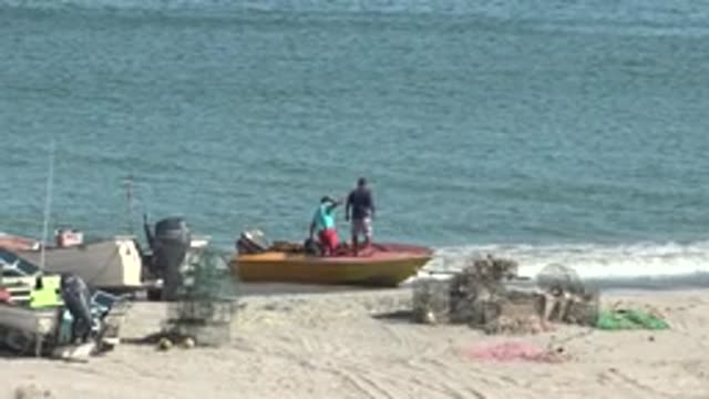 SAN JUANICO BCS MEXICO-2022: Two People on a Small Boat at the Beach