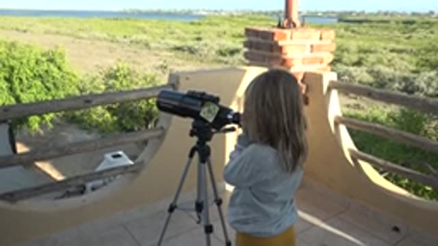 SAN CARLOS BCS MEXICO-2022: Child Observing Through Telescope on Outdoor Platform