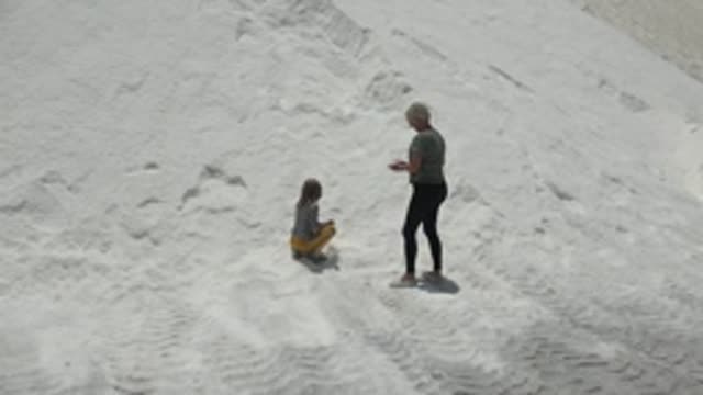 GUERRERO NEGRO BCS MEXICO-2022: Child and Adult Interacting on Sandy Beach
