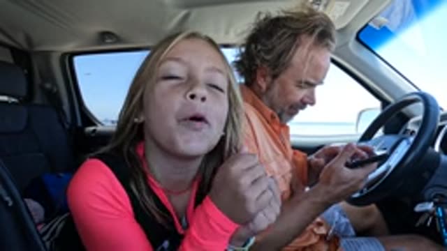 BAJA CALIFORNIA MEXICO-2022: Girl Making Playful Faces in Car While Man Drives