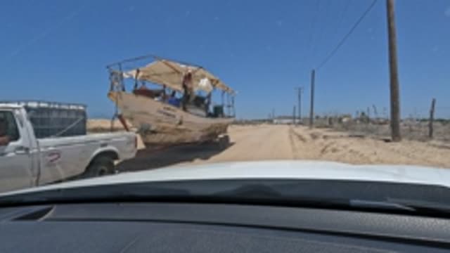 BAJA CALIFORNIA MEXICO-2022: Pickup Towing Boat on Sandy Road, Car's View