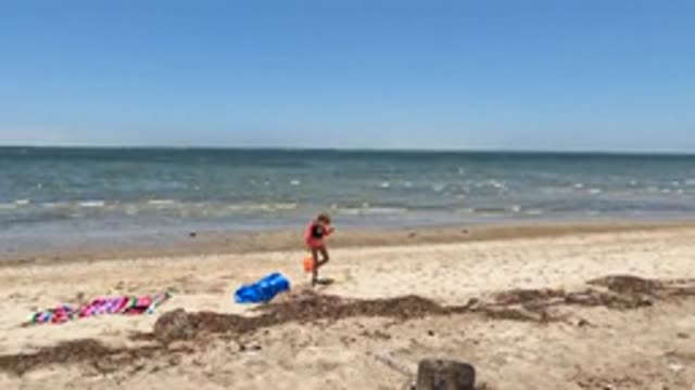 BAJA CALIFORNIA MEXICO-2022: Child Playing with Sand on a Sunny Beach