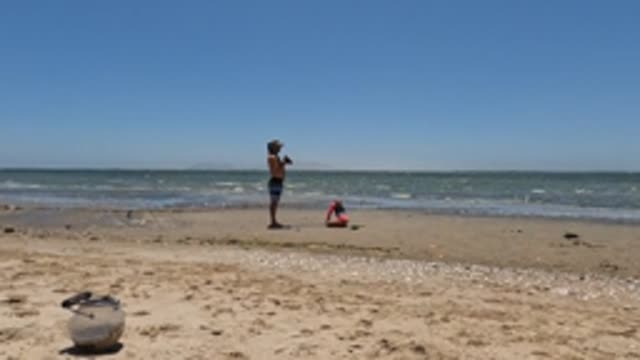 BAJA CALIFORNIA MEXICO-2022: Two People on a Sandy Beach by the Ocean