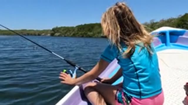 BAJA CALIFORNIA MEXICO-2022: Girl Fishing From a Boat on Calm Water