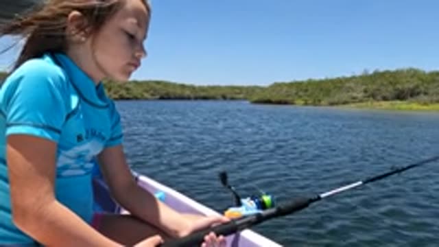 BAJA CALIFORNIA MEXICO-2022: Girl Fishing From a Boat on Calm Water