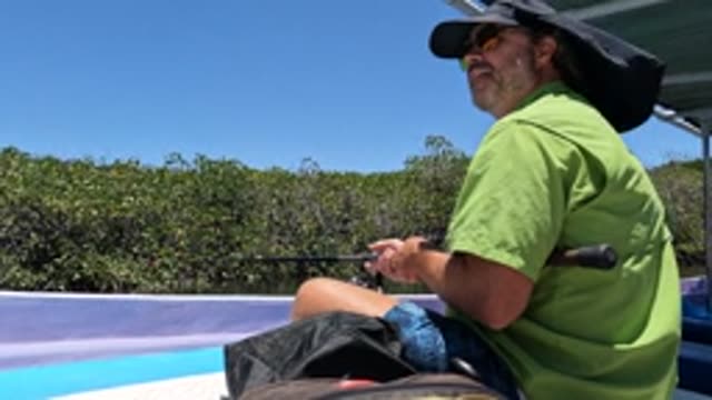 BAJA CALIFORNIA MEXICO-2022: Man Fishing on a Boat in a Mangrove Waterway