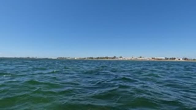 BAJA CALIFORNIA MEXICO-2022: Ocean Waves and Distant Shoreline Under Clear Sky