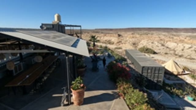 BAJA CALIFORNIA MEXICO-2022: People Walking in a Desert Courtyard with Covered Seating