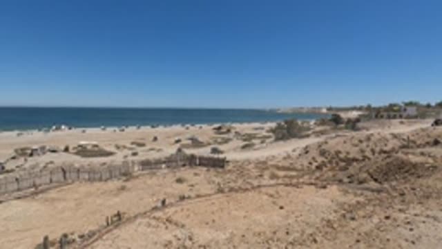 BAJA CALIFORNIA MEXICO-2022: SUV Driving on Sandy Beach Coastline