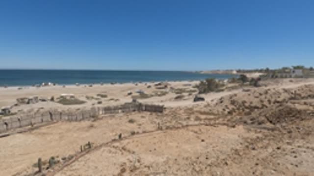 BAJA CALIFORNIA MEXICO-2022: Beach with Vehicle Moving Along Dirt Path
