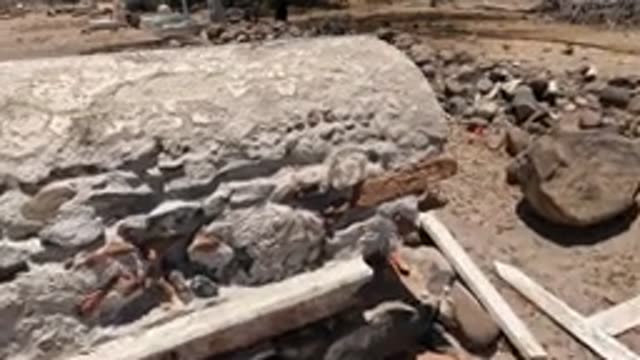 BAJA CALIFORNIA MEXICO-2022: Stone Construction Site with Workers and Red Building