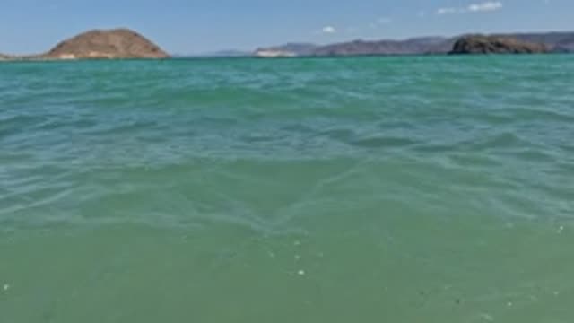 BAJA CALIFORNIA MEXICO-2022: Calm Sea with Rocky Islands in Background