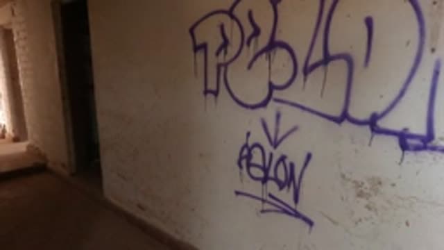BAJA CALIFORNIA MEXICO-2022: Camera Moving Past Graffiti in an Abandoned Building