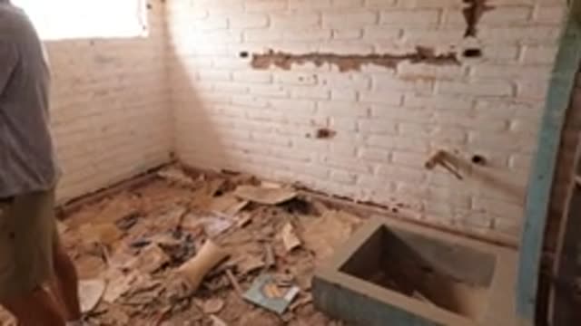 BAJA CALIFORNIA MEXICO-2022: Person Walking Through Abandoned Room with Debris