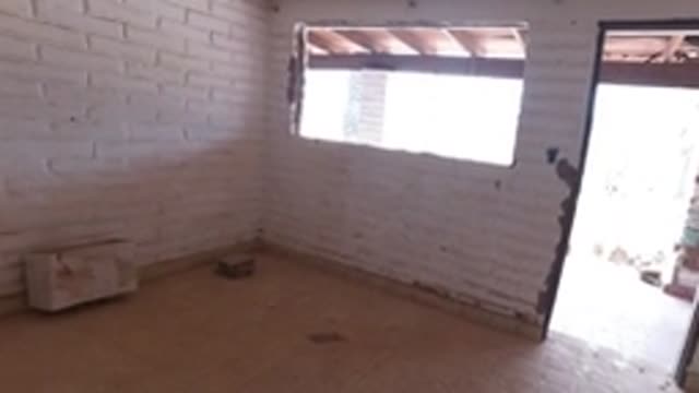 BAJA CALIFORNIA MEXICO-2022: Child Walking Through Unfinished Room with Brick Walls
