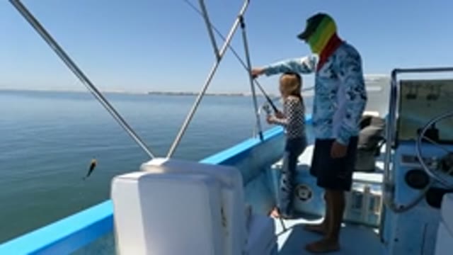BAJA CALIFORNIA MEXICO-2022: Adult and Child Fishing From a Boat