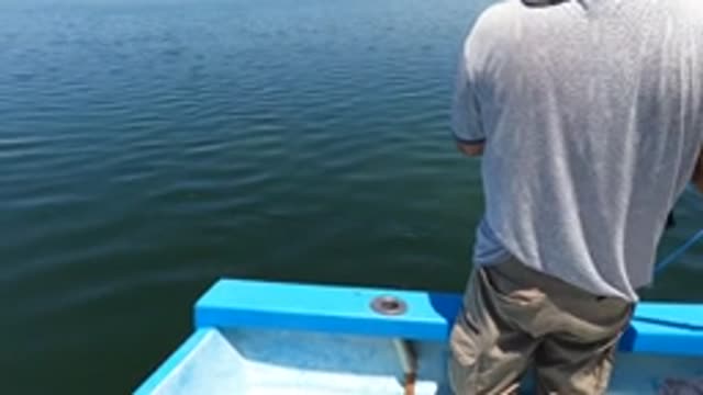 BAJA CALIFORNIA MEXICO-2022: Man Fishing From a Small Boat on Calm Water