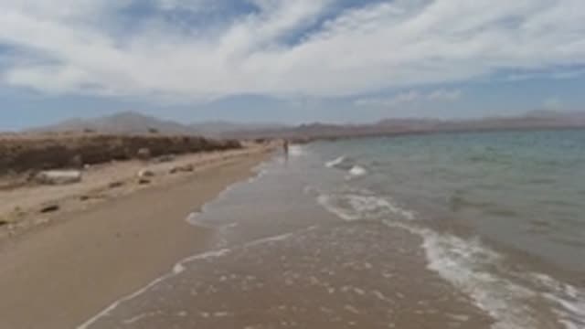 BAJA CALIFORNIA MEXICO-2022: Gentle Ocean Waves Lapping Sandy Shore