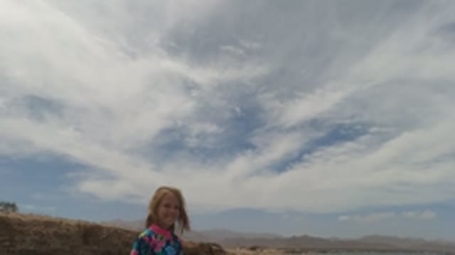 BAJA CALIFORNIA MEXICO-2022: Girl in Floral Shirt Approaching Camera by the Ocean